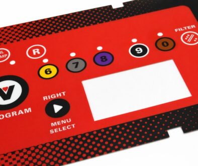 Red polycarbonate control panel overlay manufactured by Metallics, Inc. with color-coded numbered buttons, oil temperature and filter icons, menu controls, and a display cutout.